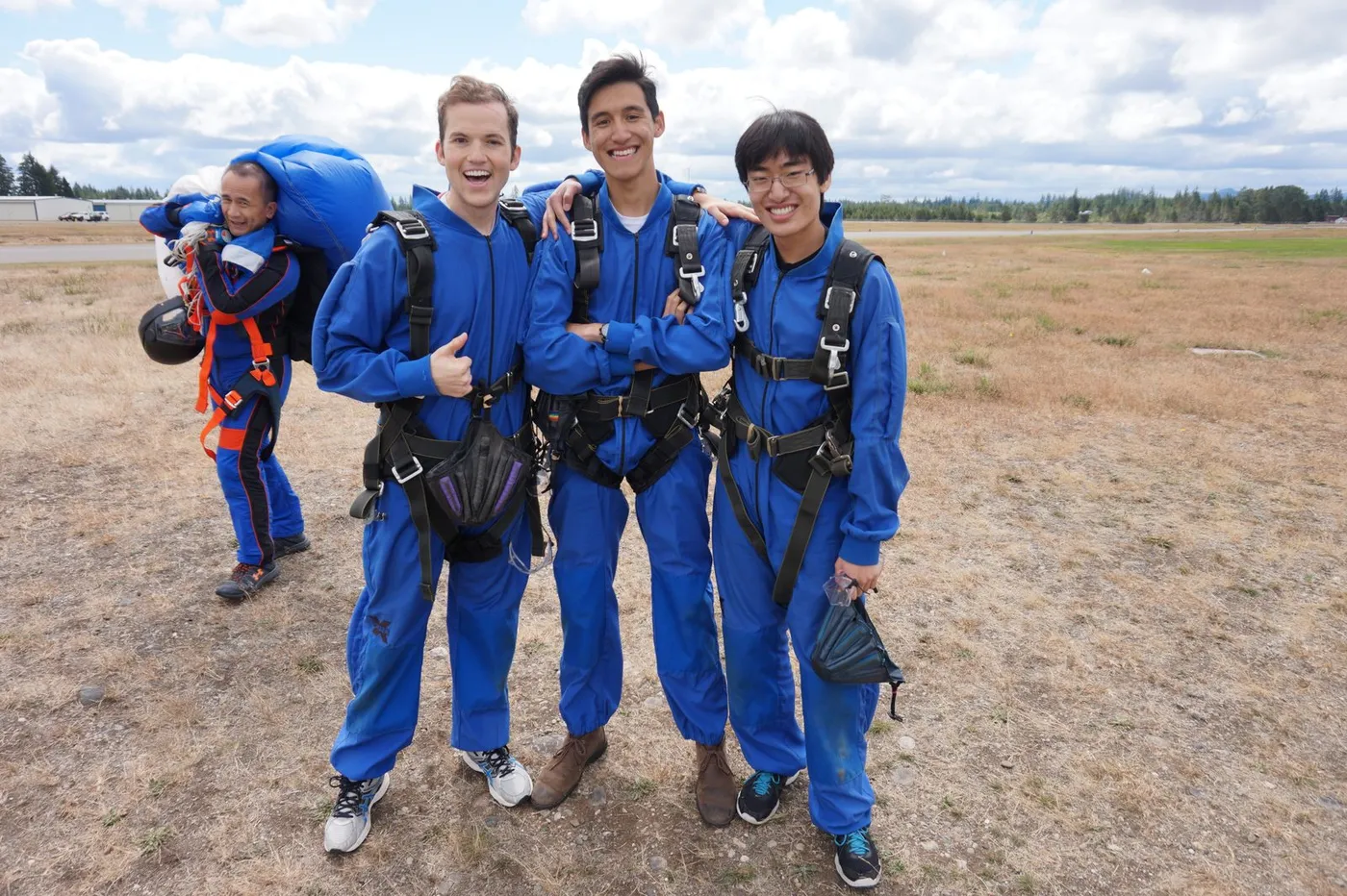 Back on solid ground at the airfield in our blue jumpsuits after the jump.
